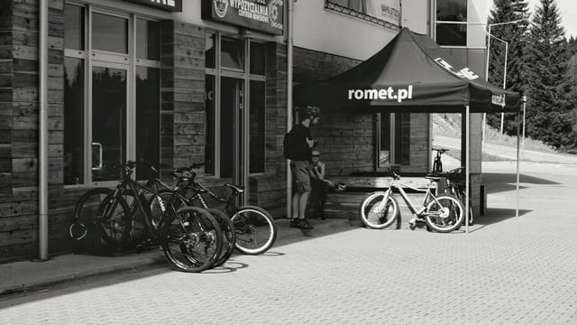 Outdoor scene with bicycles for rent at a shop in Świeradów-Zdrój, Poland.