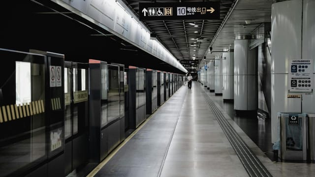 Wide view of a deserted platform in a Shanghai Metro station, showcasing modern architecture.