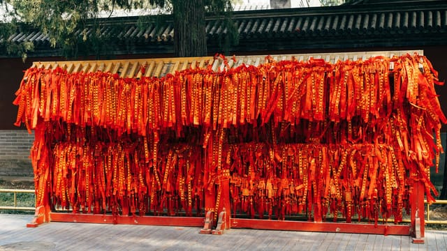 Bright red traditional ribbons hanging in a vibrant display, symbolizing culture and celebration.
