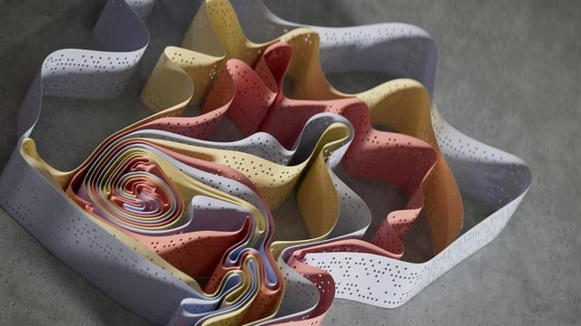 Multicolored ribbons create a flowing abstract design on a grey background.