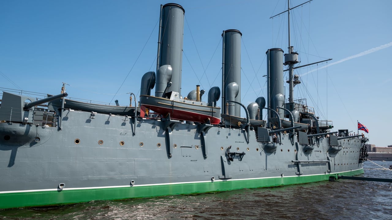 Side view of the Aurora cruiser ship docked on a sunny day in Saint Petersburg.