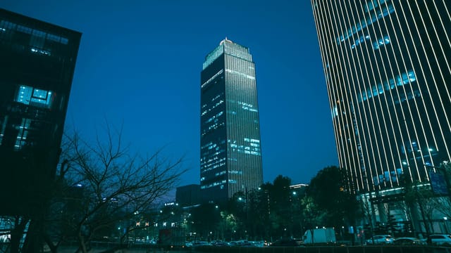 Majestic skyscrapers in Hangzhou, China, illuminate the twilight skyline with modern architectural designs.