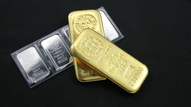 Close-up of gold and platinum bars depicting wealth and investment potential.