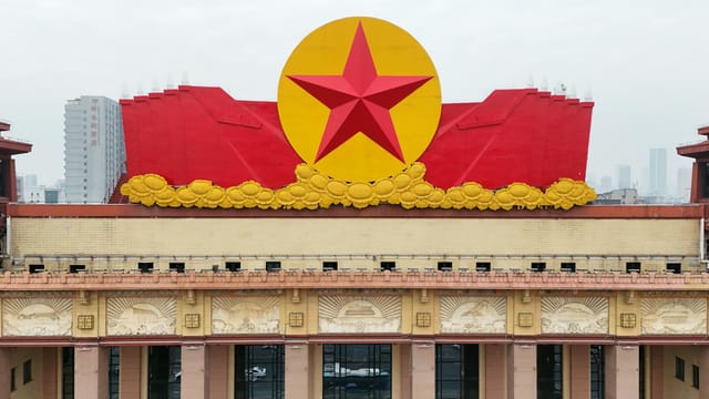 A vibrant red star adorns a building's facade, symbolizing historical significance in Nanchang, China.