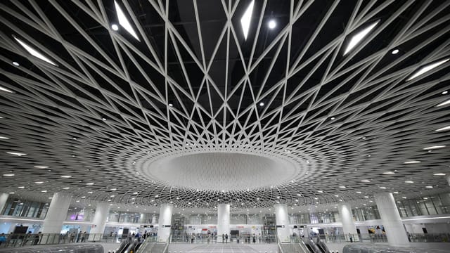 Modern architecture and escalators in Gangxia North Station, Shenzhen, China.