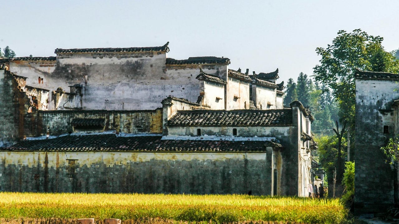 Ancient buildings with classic Chinese architecture set against a rural backdrop in Shangrao, Jiangxi Province.