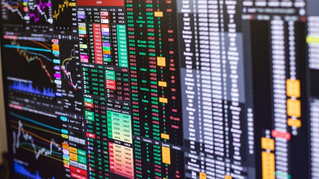 Detailed financial trading screen with colorful charts and data representing market fluctuations.