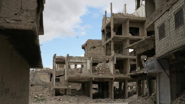 A haunting view of abandoned and destroyed buildings in Damascus, reflecting the impact of conflict.