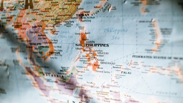 Closeup of paper world map with selective focus of Philippines surrounded by seas