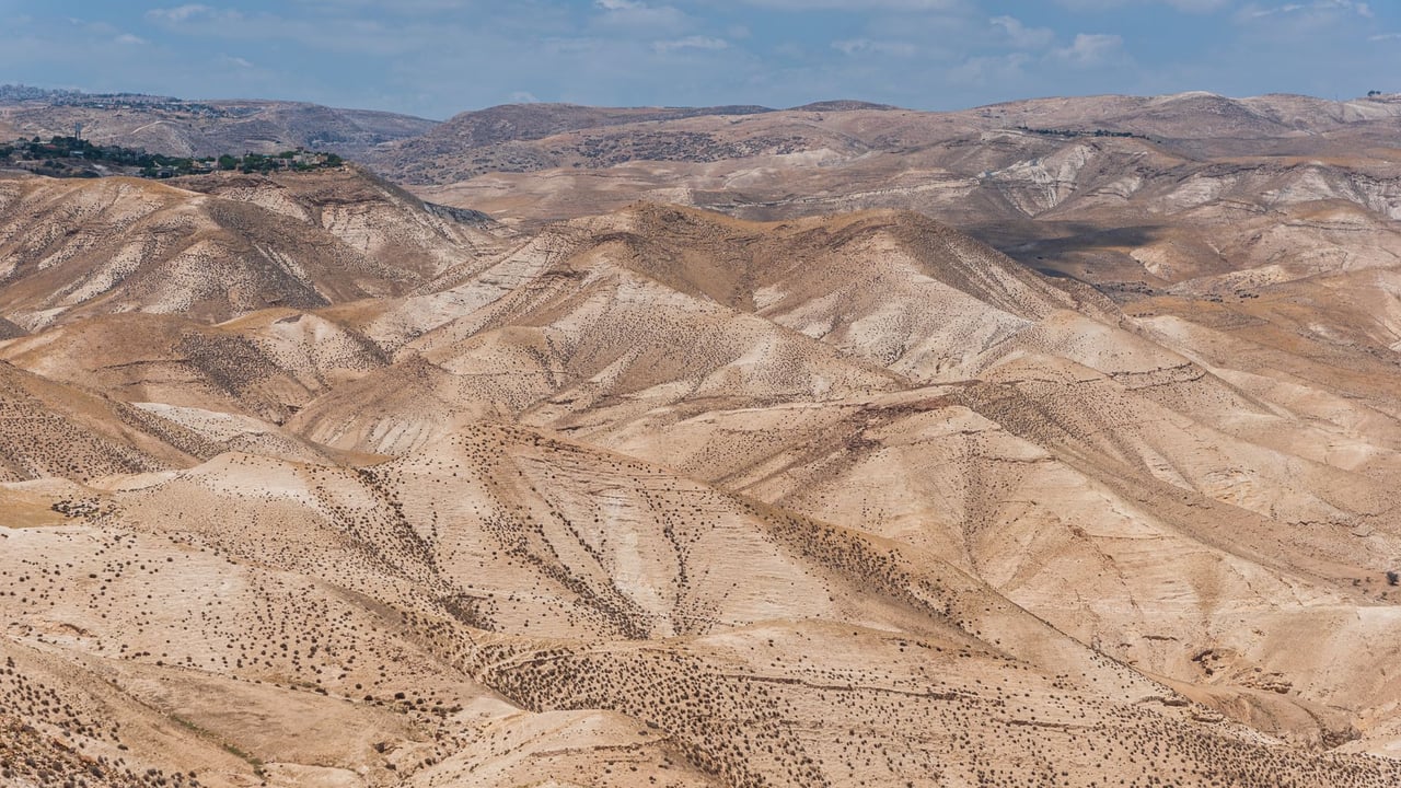 Scenic view of arid desert hills under a clear blue sky in Israel.