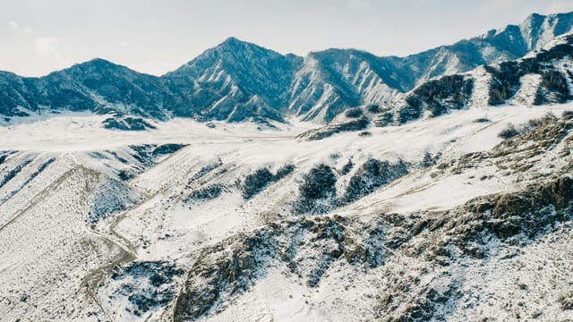 Stunning aerial photo capturing snow-covered mountains in a winter view of Russia.