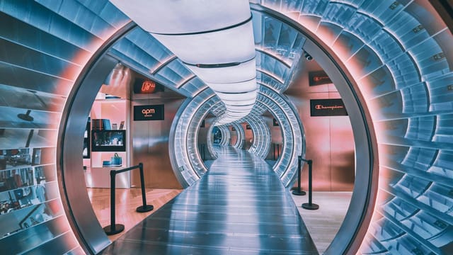 A vibrant, illuminated tunnel with neon colors and modern design inside a mall in Beijing.