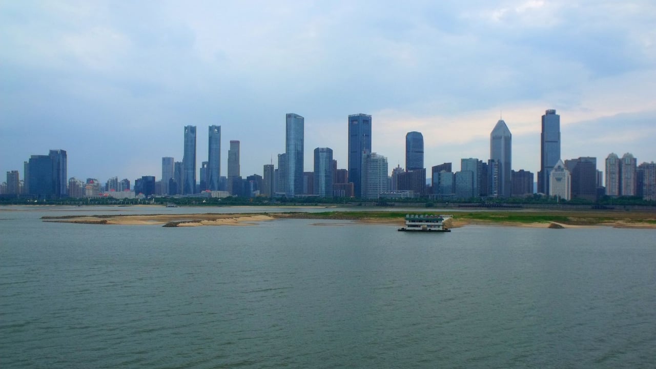 Panoramic view of Nanchang's skyline across the harbor with modern skyscrapers and river.