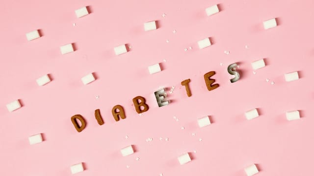 Artistic diabetes awareness design featuring sugar cubes and text on pink background.