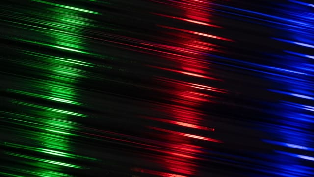 Vivid red, green, and blue light streaks create an abstract and futuristic look.