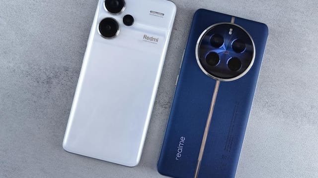 Two smartphones, one white and one blue, displayed on a textured grey background.