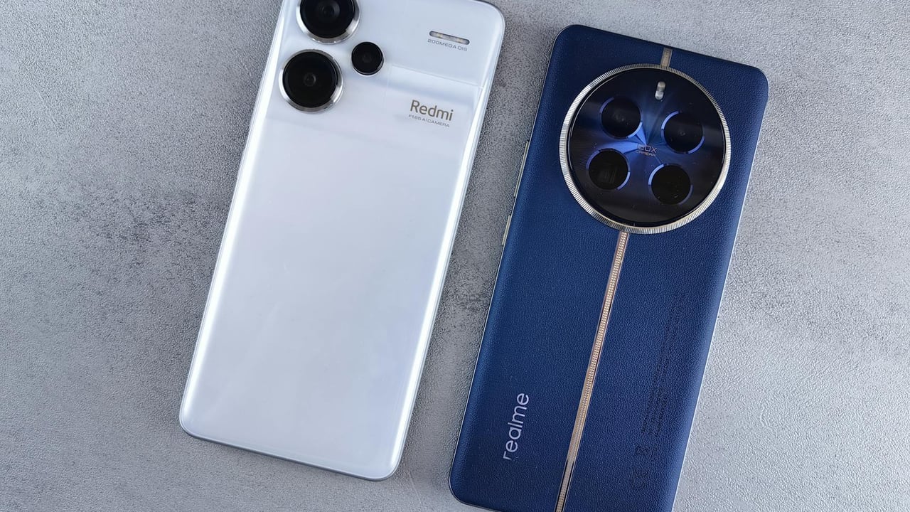 Two smartphones, one white and one blue, displayed on a textured grey background.