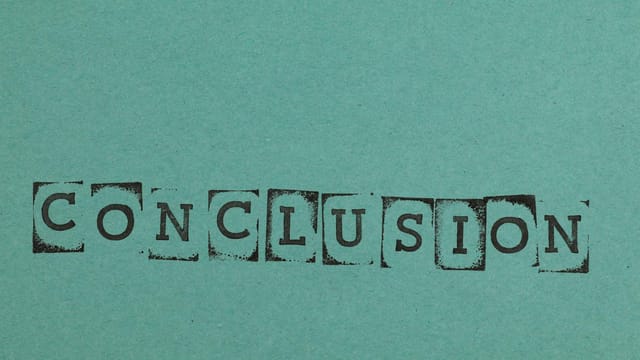 Conclusion word stamped on textured blue paper with block letters, conveying finality.