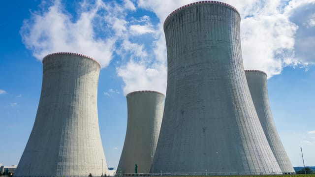 Cooling towers of Dukovany Nuclear Power Plant against a clear blue sky.
