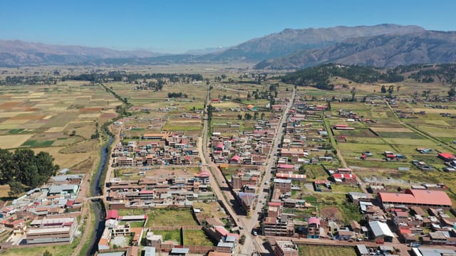 Aerial shot of Anta village with scenic fields and Andes mountains in Cuzco, Peru.