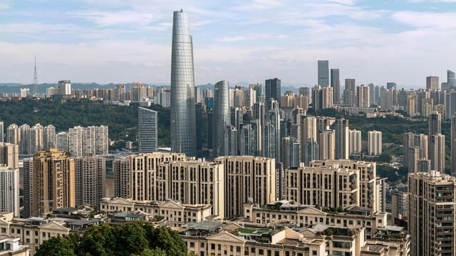 A dynamic cityscape showcasing tall skyscrapers under a clear sky, highlighting urban architecture.