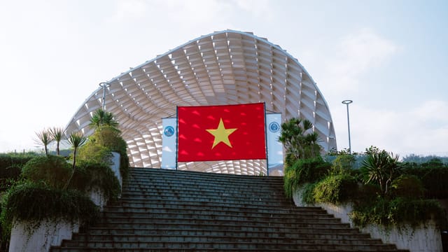 Vietnamese flag at a prominent architectural structure in Đà Nẵng.