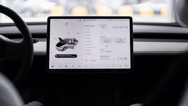 View of a modern car's dashboard featuring a digital display panel with control options.