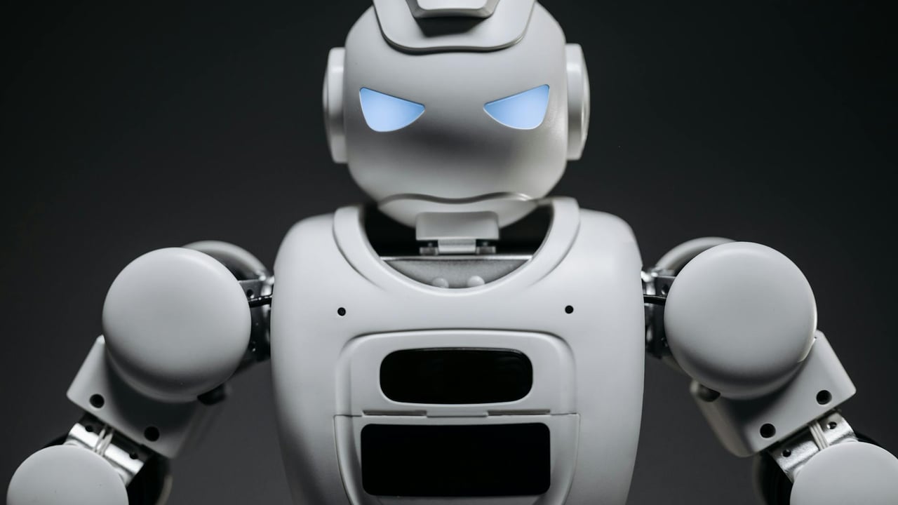 Detailed studio shot of a modern robotic toy with a dark background, showcasing technological design.