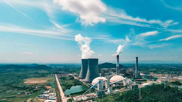 Aerial view of an industrial power plant near Jiujiang, showcasing infrastructure and landscape.