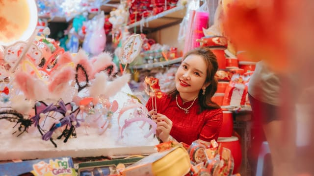 Vibrant market scene with a woman in a red dress surrounded by fun festive accessories.
