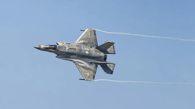 An F-35 Lightning jet soaring in the sky, showcasing advanced stealth capabilities.