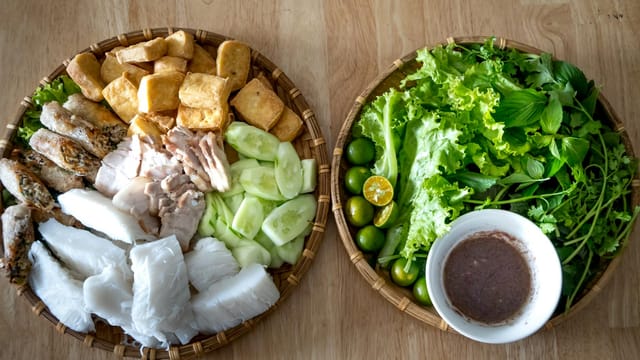 Delicious Vietnamese bun dan mam tom with herbs and fresh vegetables served traditionally.