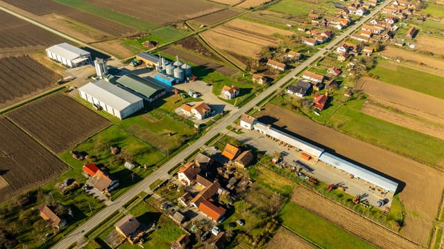 Aerial view of rural landscape in Garešnica, Croatia with farmlands and buildings.