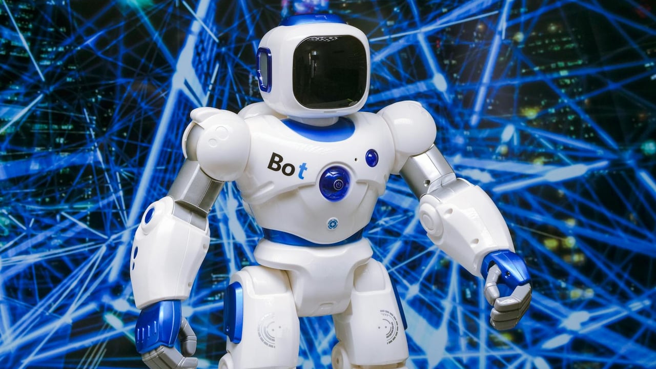 Advanced humanoid robot with glowing blue accents in a digital network setting.