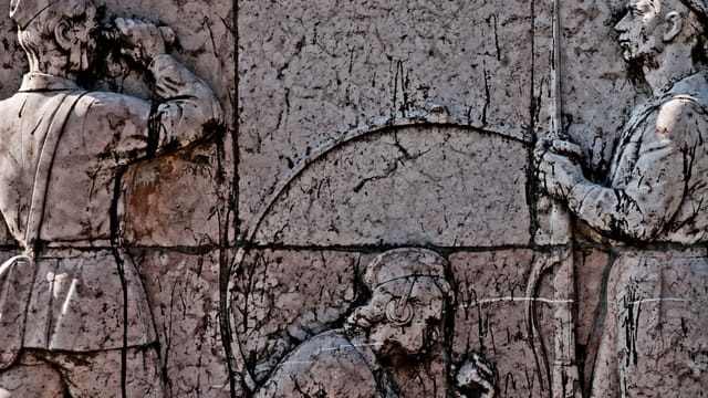 Detailed relief sculpture depicting soldiers on a monument in Budapest, Hungary.
