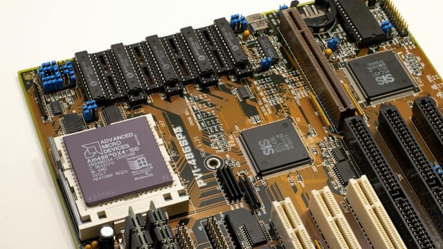 A detailed close-up of a vintage motherboard highlighting microprocessor and electronics components.
