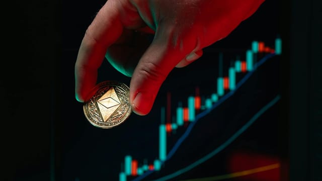 A hand holding an Ethereum coin against a rising stock market graph, symbolizing cryptocurrency growth.
