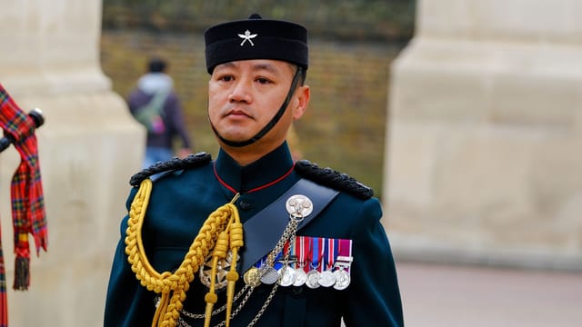 A Gurkha soldier in formal attire with medals, England, UK.