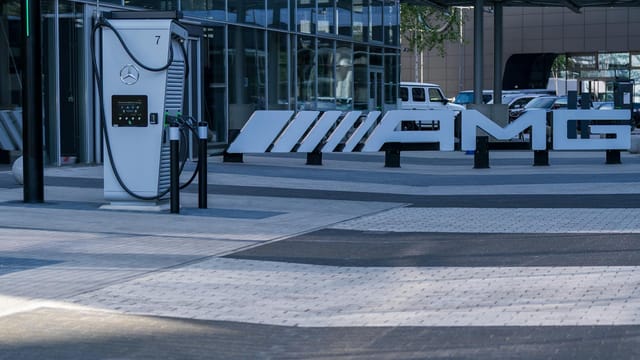 Electric vehicle charging station at a modern business complex featuring sleek architectural design.