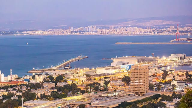 A stunning view of Haifa's harbor and cityscape in the evening light.