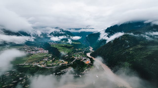 Dramatic aerial view of Nujiang Valley in Yunnan, China with river and mountains.