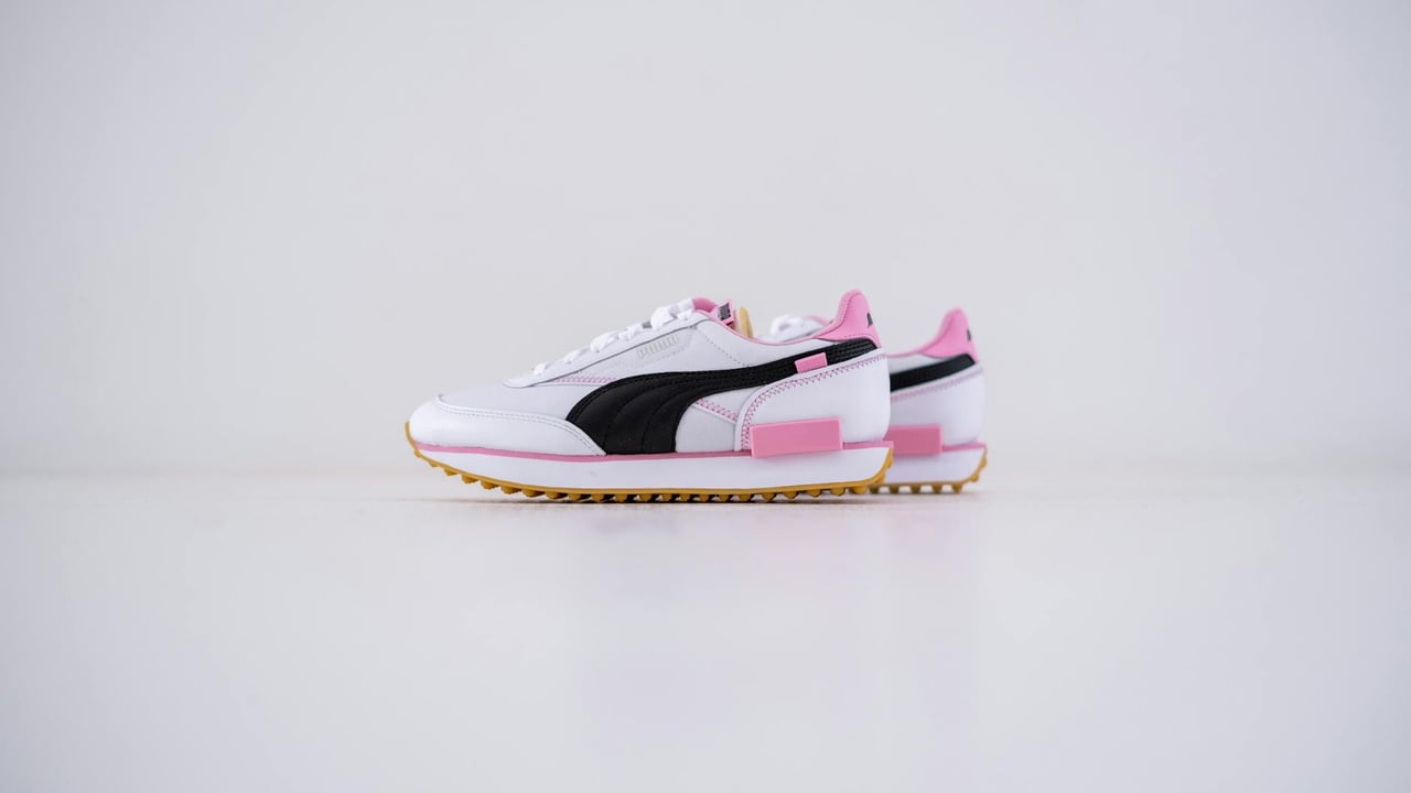 High-quality product image of stylish pink and black sneakers showcased on a clean white background.