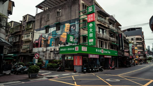 Vibrant street scene in New Taipei City with colorful murals and traditional buildings.