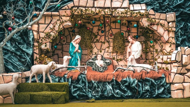 Beautifully crafted nativity scene depicting the birth of Jesus with Mary, Joseph, and shepherds.