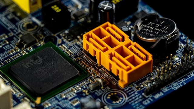 Detailed view of a computer motherboard showcasing an Intel microprocessor and electronic components.