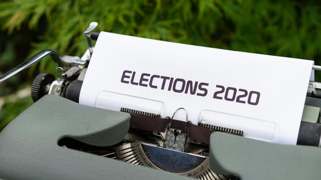 Close-up of a typewriter typing 'Elections 2020' outdoors.