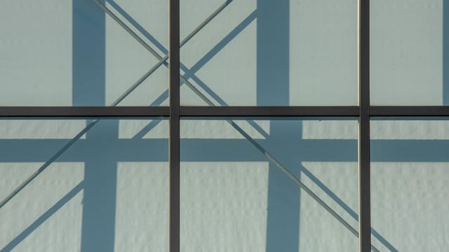 Abstract view of a modern steel structure with intersecting shadows.
