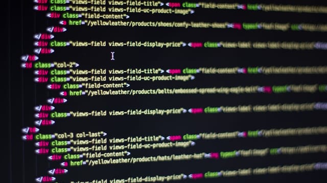 Detailed close-up of HTML code on a computer monitor, showcasing web development.