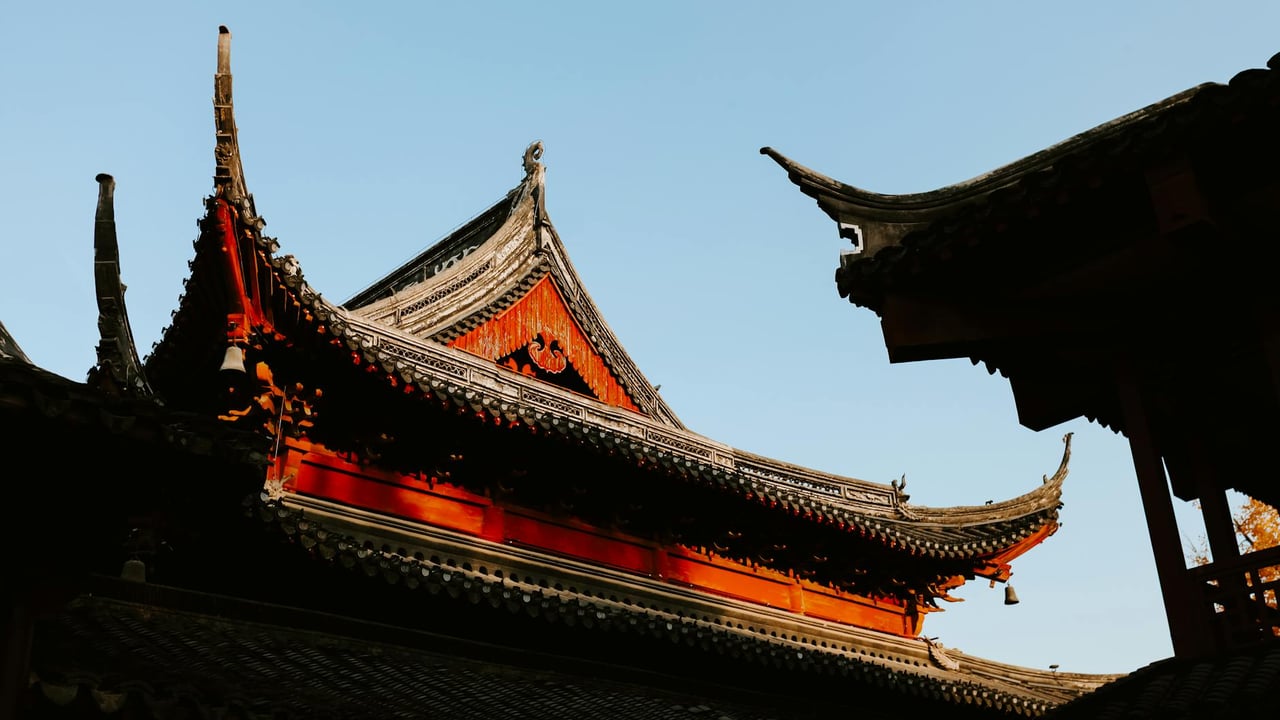 View of traditional Chinese temple roofs in Nanjing during autumn, showcasing intricate architectural details.