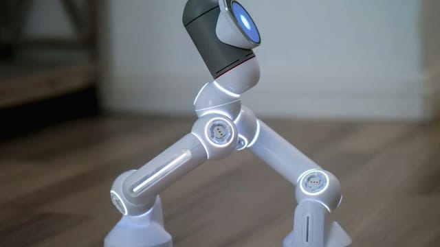 Side view of a modern robot walking on a wooden surface, showcasing advanced technology.